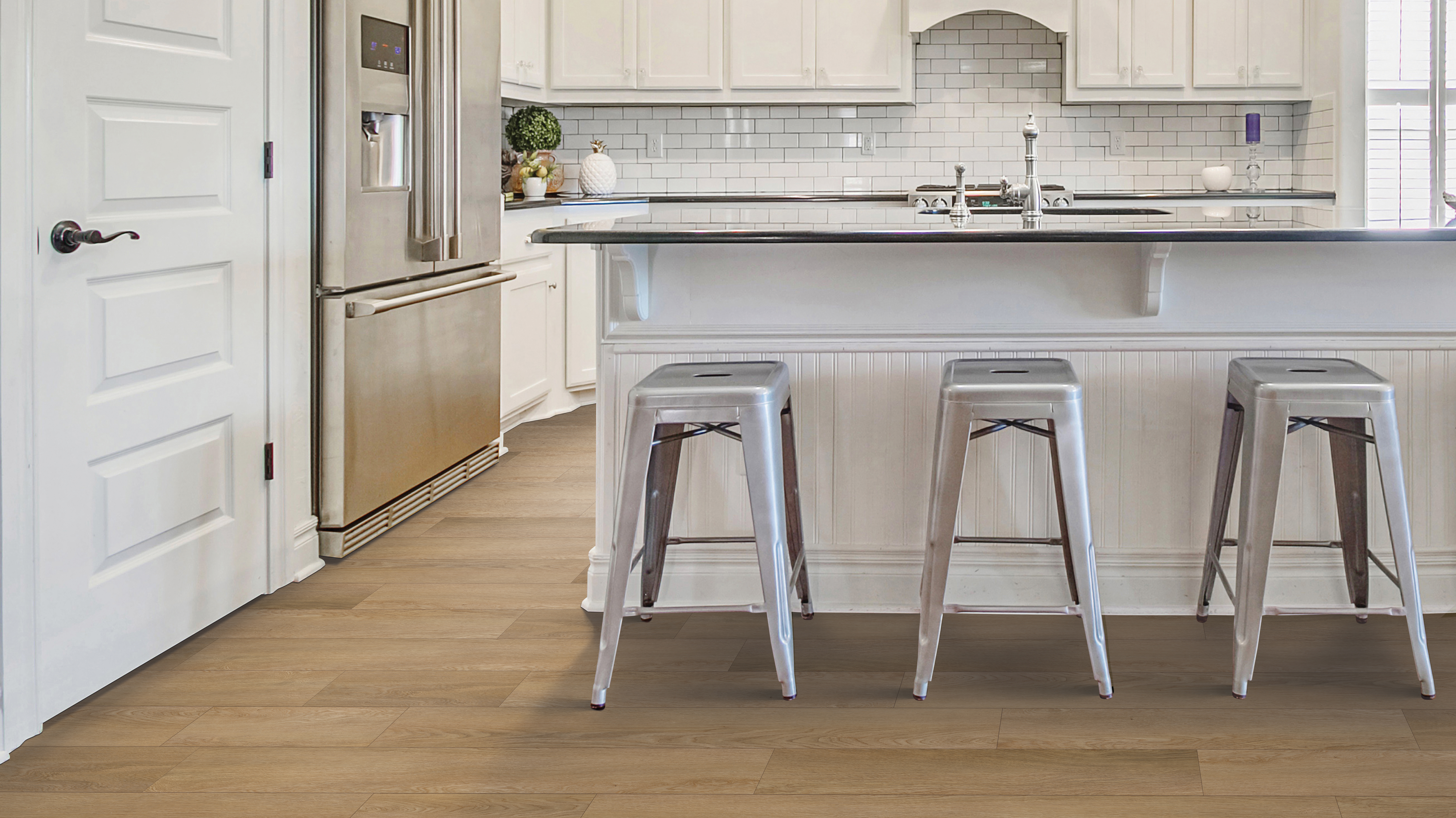 Newly Installed Luxury Vinyl flooring in the kitchen of a home with 3 bar stools